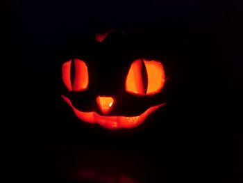 Close-up of illuminated pumpkin against black background