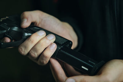 Midsection of man holding camera