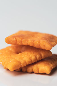 Close-up of bread in plate against white background