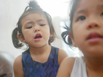 Close-up of siblings at home