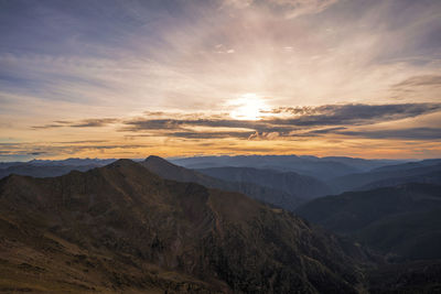 Scenic view of mountains against sky during sunset