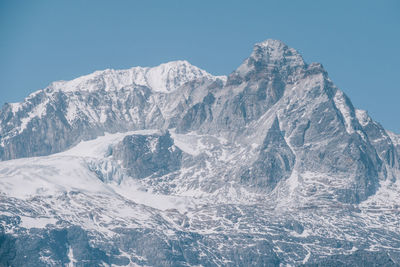 Scenic view of snowcapped mountains against clear blue sky
