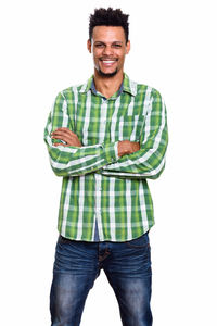 Portrait of young man standing against white background