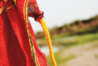Close-up of ropes tied on rope against sky