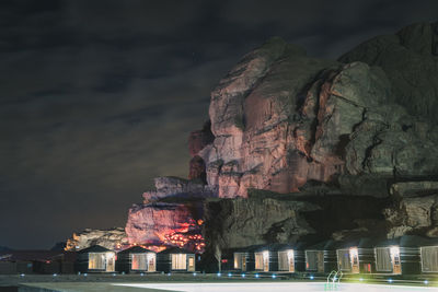 Low angle view of illuminated buildings against sky at night