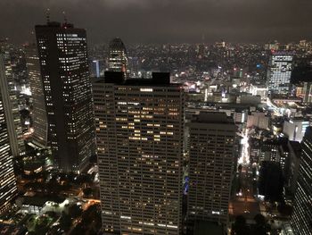 High angle view of illuminated buildings in city at night