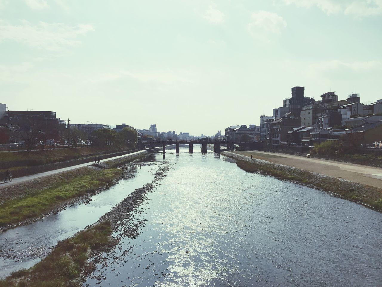 VIEW OF CITY BY WATER AGAINST SKY