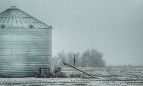 Built structure on field against sky during winter