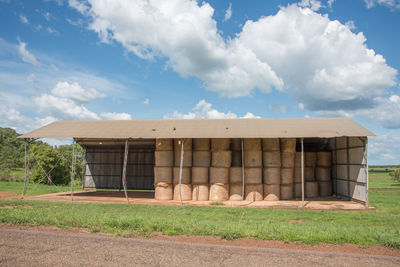 Built structure on field against sky