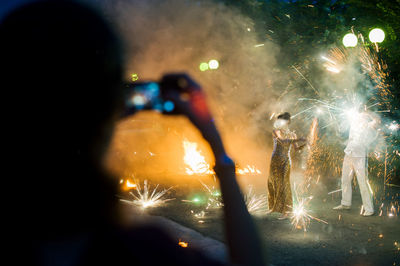 People watching firework display at night