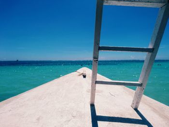 Scenic view of beach against blue sky