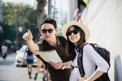 Man and woman standing on street