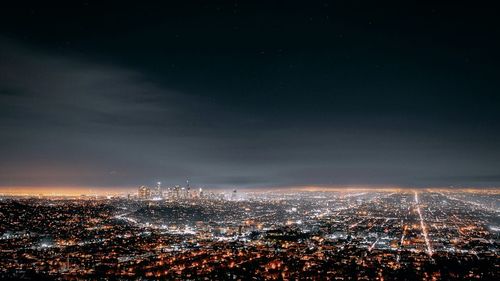 Aerial view of city lit up at night