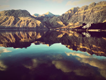 Scenic view of lake and mountains against sky