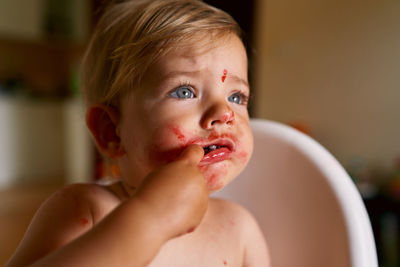 Close-up of baby girl sitting in high chair