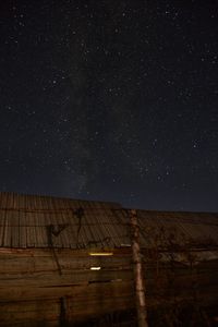 Low angle view of hut against sky at night