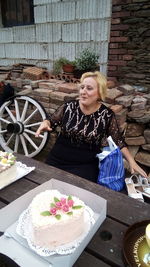 Woman with ice cream on table