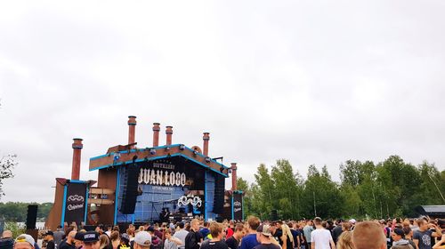 Group of people at concert against sky