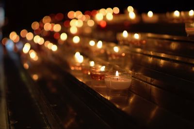 Close-up of illuminated tea light candles at night