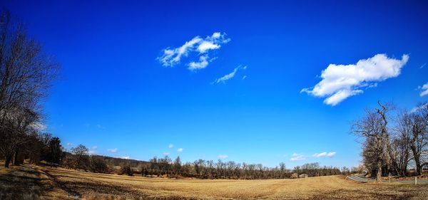 Scenic view of field against cloudy sky