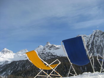 Umbrella on snow covered mountain against sky