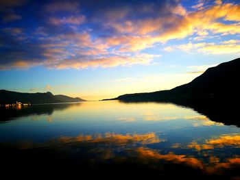 Scenic view of calm lake at sunset