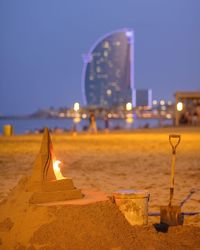 Illuminated sand castle against sky at night