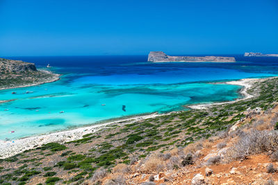 Scenic view of sea against blue sky