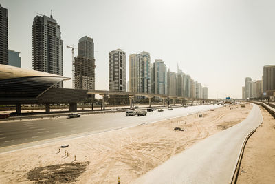 Panoramic view of beach and buildings against clear sky