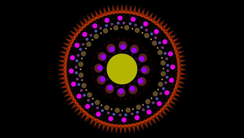 Low angle view of illuminated lights against black background