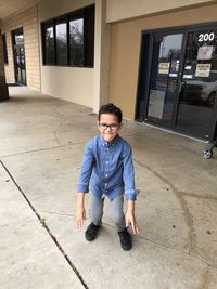 Portrait of young man sitting on floor