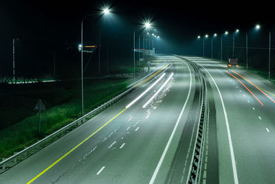 High angle view of light trails on road in city at night