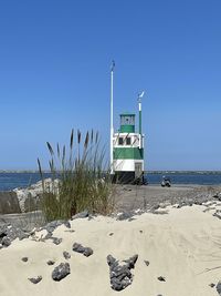 Lifeguard hut on beach against clear sky