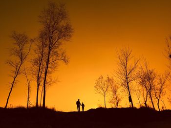 Family on landscape against sky