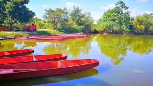 Boat moored in lake against sky