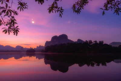 Scenic view of lake against sky during sunset