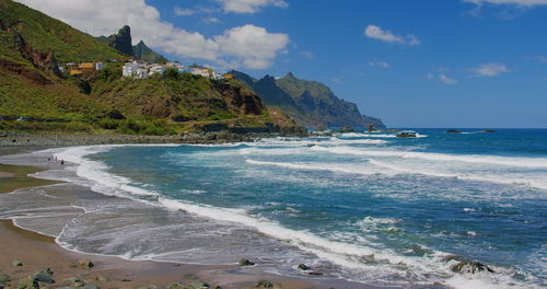 Rocky mountain coastline in the north of tenerife. almaciga beach with cute colorful village.