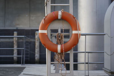 Fire hydrant on railing against orange wall