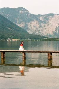 Rear view of man standing by railing