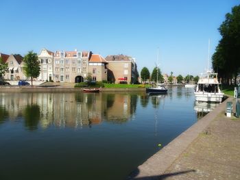 Boats in river with buildings in background