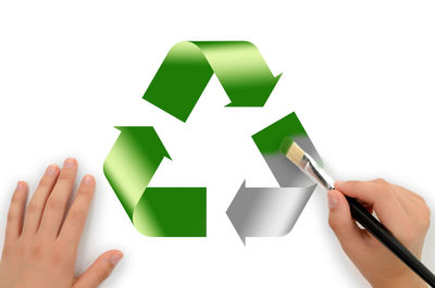 Midsection of person holding paper against white background