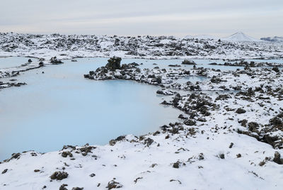 Scenic view of frozen lake against sky