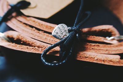 High angle view of heart shape with text on leather strap