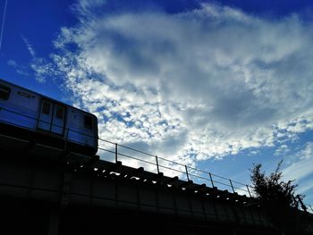 Low angle view of building against cloudy sky