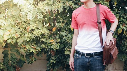 Midsection of man standing by plants