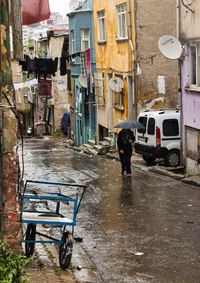 Rear view of man sitting on street