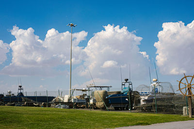 Sailboats moored at harbor against sky