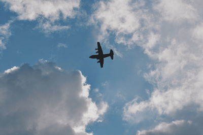 Low angle view of airplane flying in sky