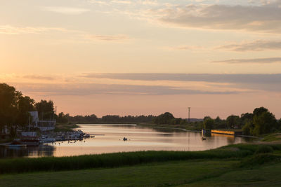 Scenic view of river at sunset