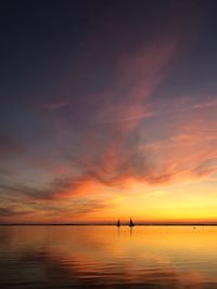 Scenic view of sea against romantic sky at sunset